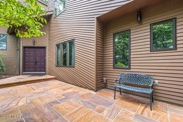a view of a wooden bench in the back yard