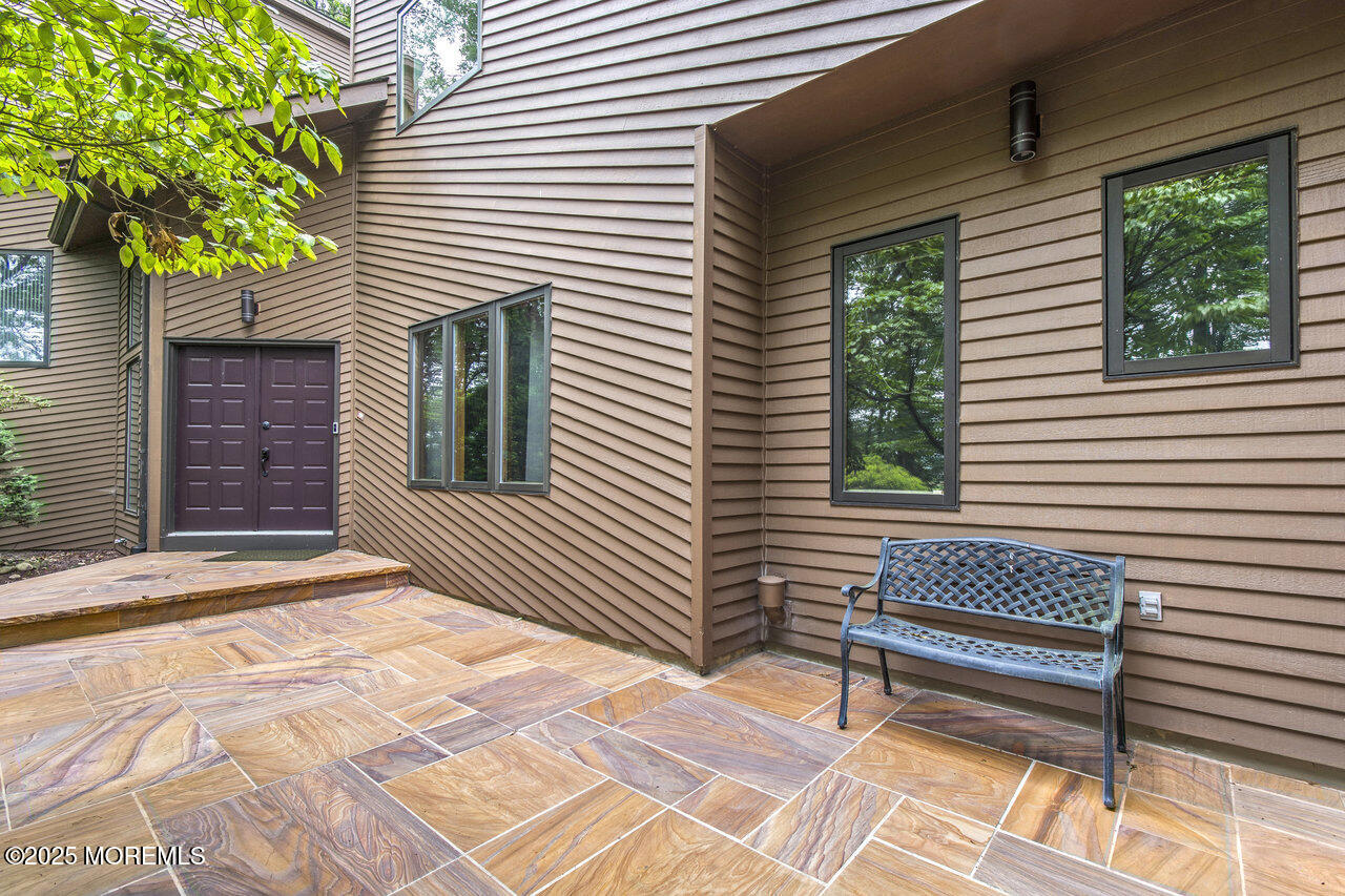 31 Thompson Grove Road Freehold, NJ 07728 - Photo 13 of 54 a view of a wooden bench in the back yard