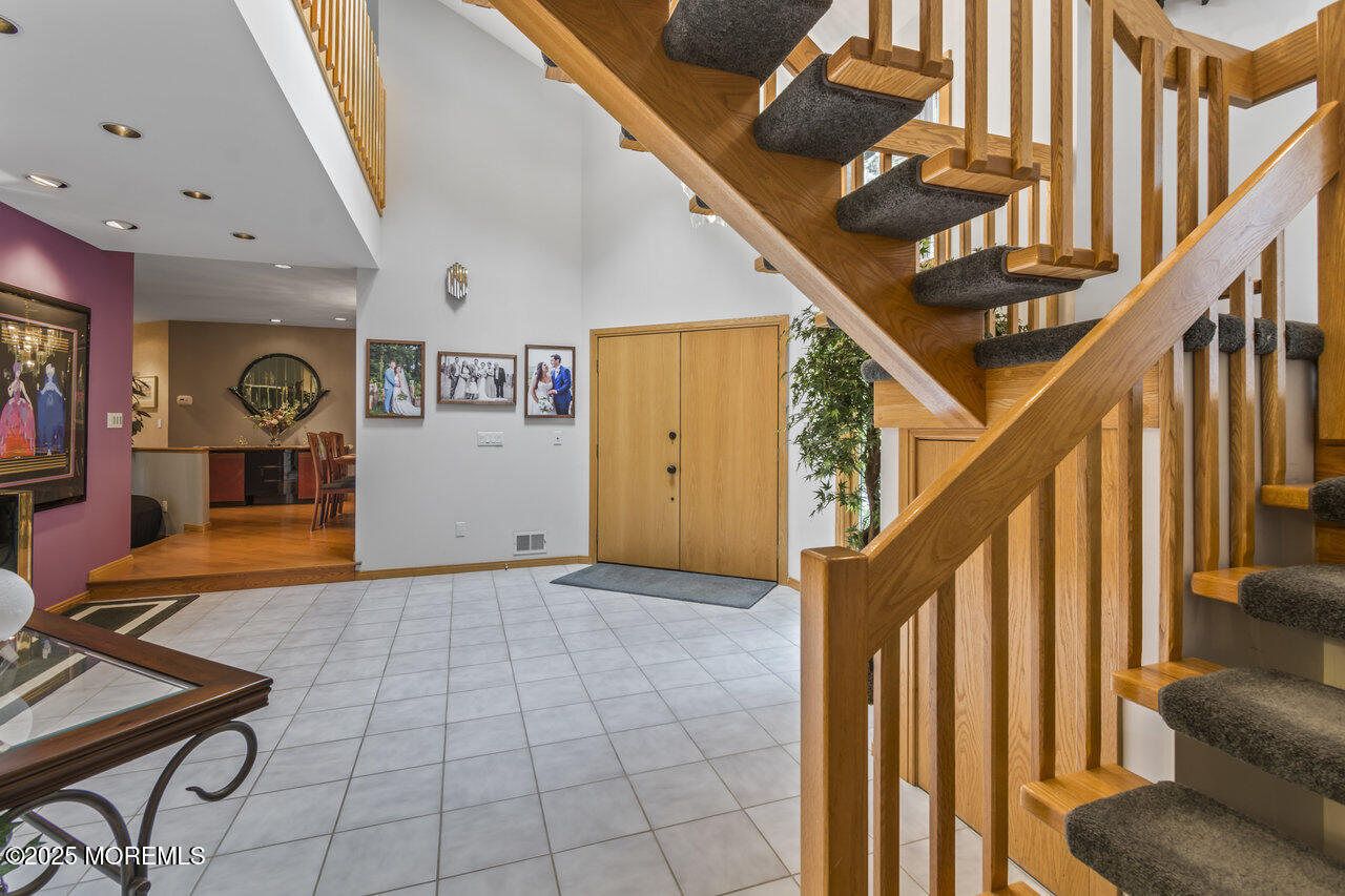 31 Thompson Grove Road Freehold, NJ 07728 - Photo 17 of 54 a view of an entryway with wooden floor and stairs