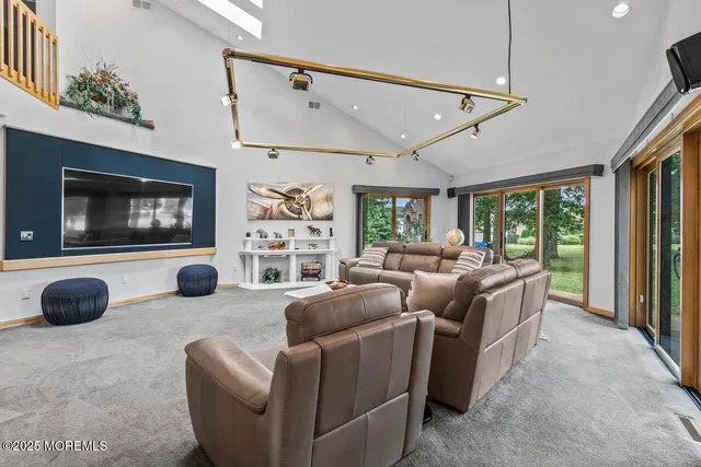 a view of a dining room with furniture a chandelier and wooden floor