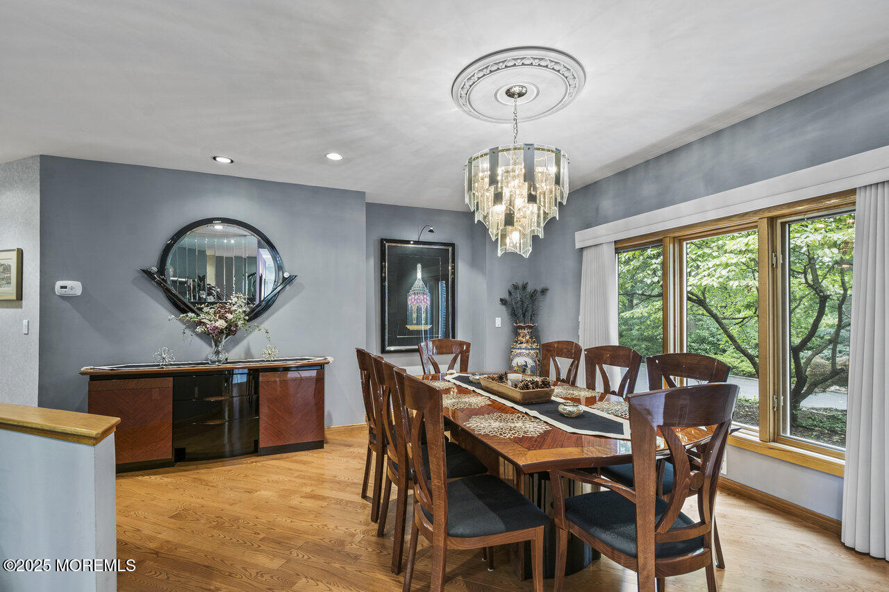 31 Thompson Grove Road Freehold, NJ 07728 - Photo 29 of 54 a view of a dining room with furniture a chandelier and wooden floor