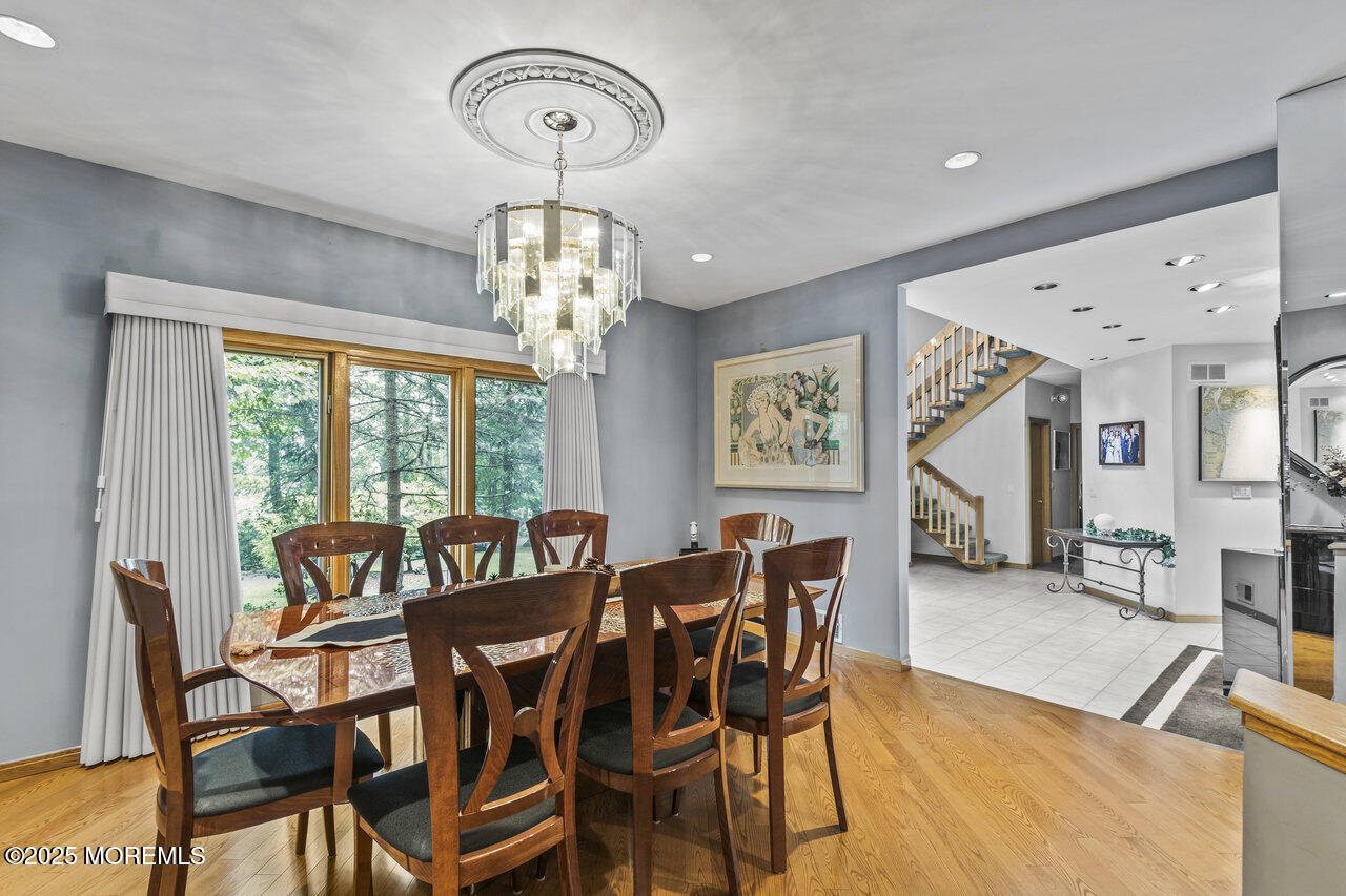 31 Thompson Grove Road Freehold, NJ 07728 - Photo 30 of 54 a view of a dining room with furniture a chandelier and a large window