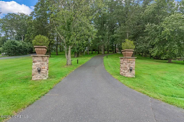 a front view of a house with a yard and a street
