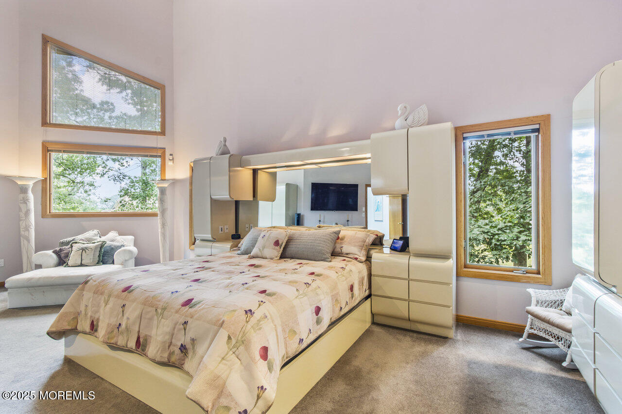 31 Thompson Grove Road Freehold, NJ 07728 - Photo 31 of 54 a bedroom with a bed and large windows