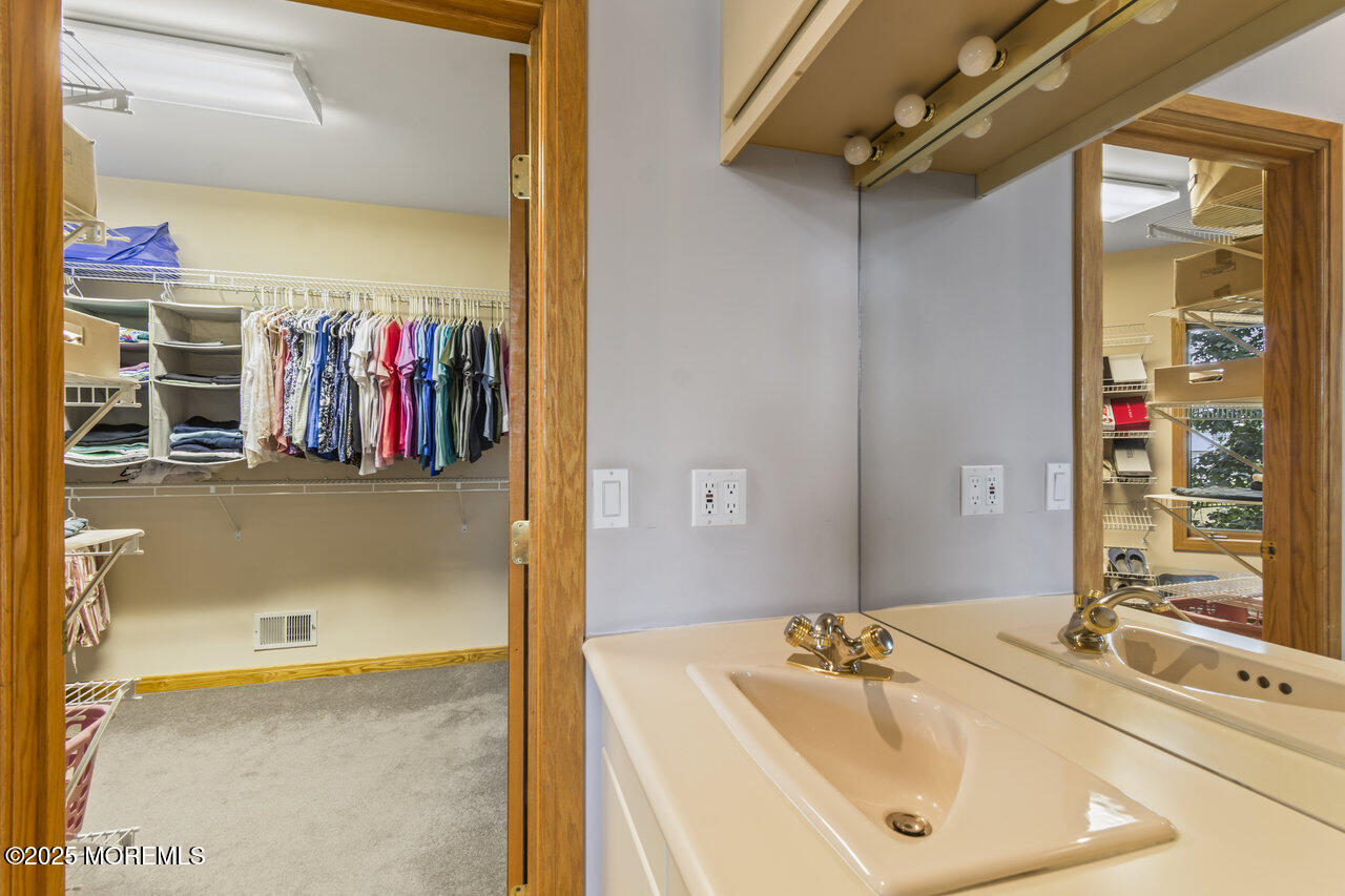 31 Thompson Grove Road Freehold, NJ 07728 - Photo 34 of 54 a bathroom with a tub sink and mirror