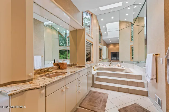 a bath tub sitting next to a bathroom sink