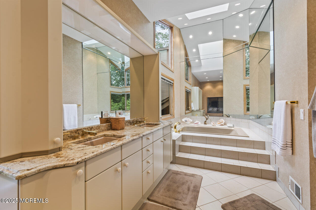 31 Thompson Grove Road Freehold, NJ 07728 - Photo 36 of 54 a spacious bathroom with a sink and a large mirror