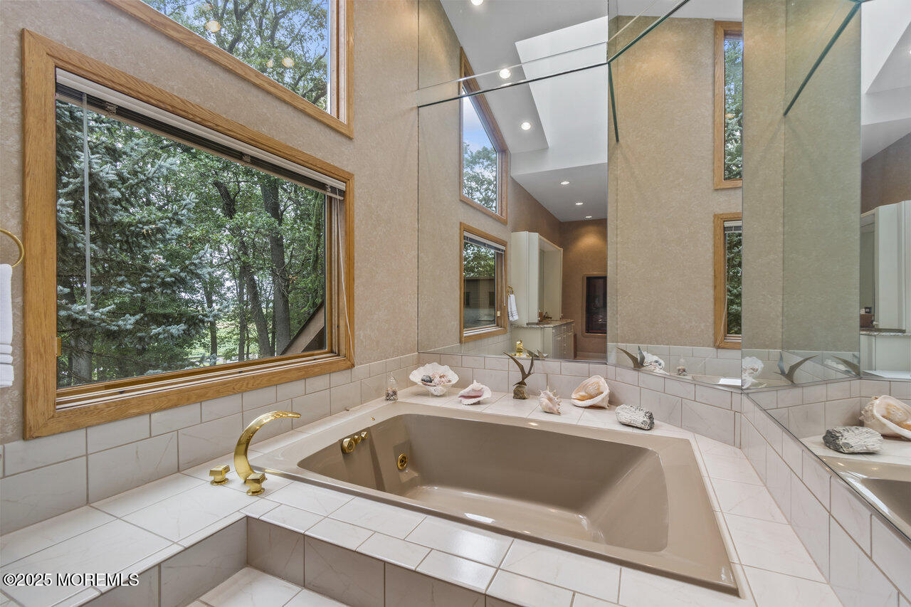 31 Thompson Grove Road Freehold, NJ 07728 - Photo 39 of 54 a bath tub sitting next to a bathroom sink