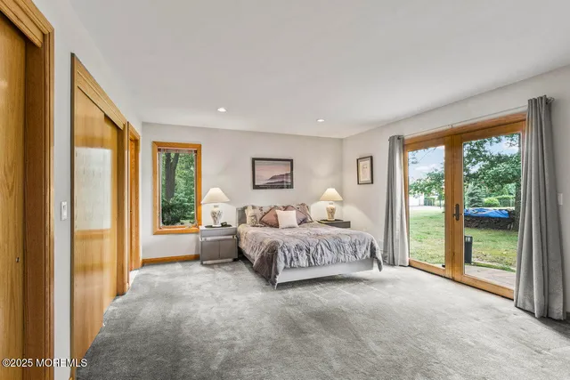 a big room with chandelier fan and furniture