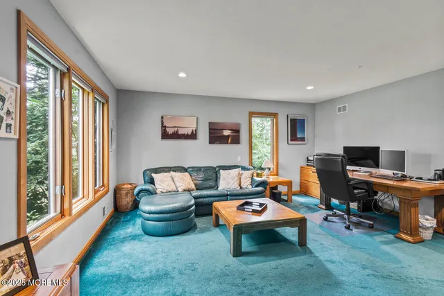 a view of a patio with a table and chairs under an umbrella