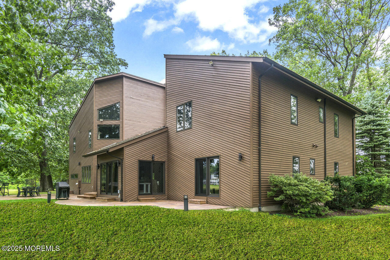 31 Thompson Grove Road Freehold, NJ 07728 - Photo 5 of 54 a front view of a house with a yard and trees