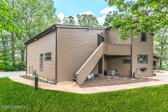 a view of a house with a yard and tree