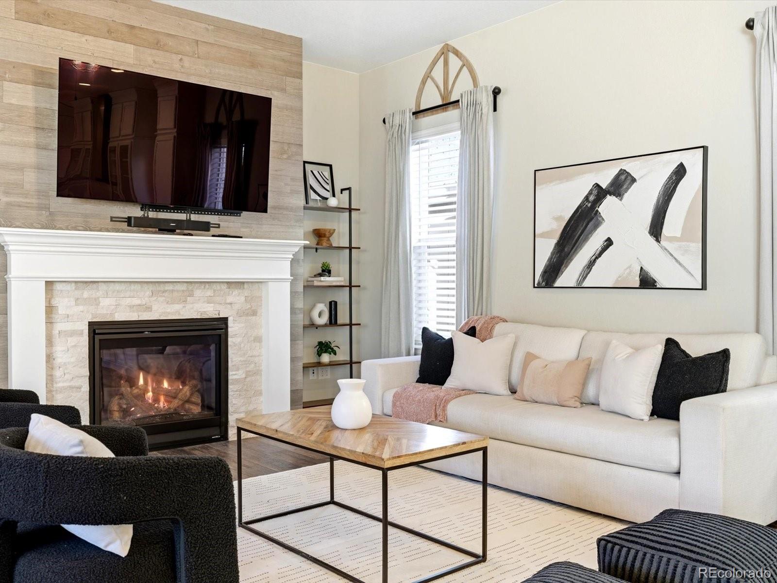 6579 South Vaughn Street Centennial, CO 80111 - Photo 11 of 44 a living room with furniture and a fireplace