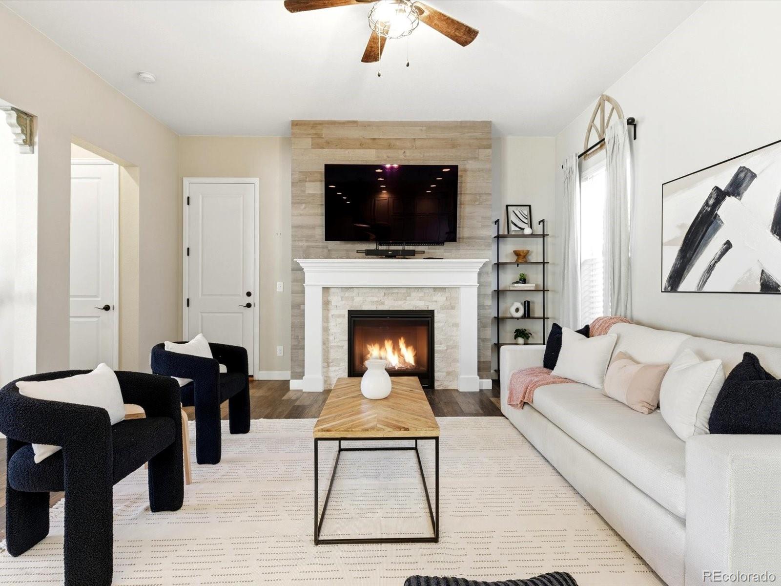 6579 South Vaughn Street Centennial, CO 80111 - Photo 12 of 44 a living room with furniture fireplace and flat screen tv