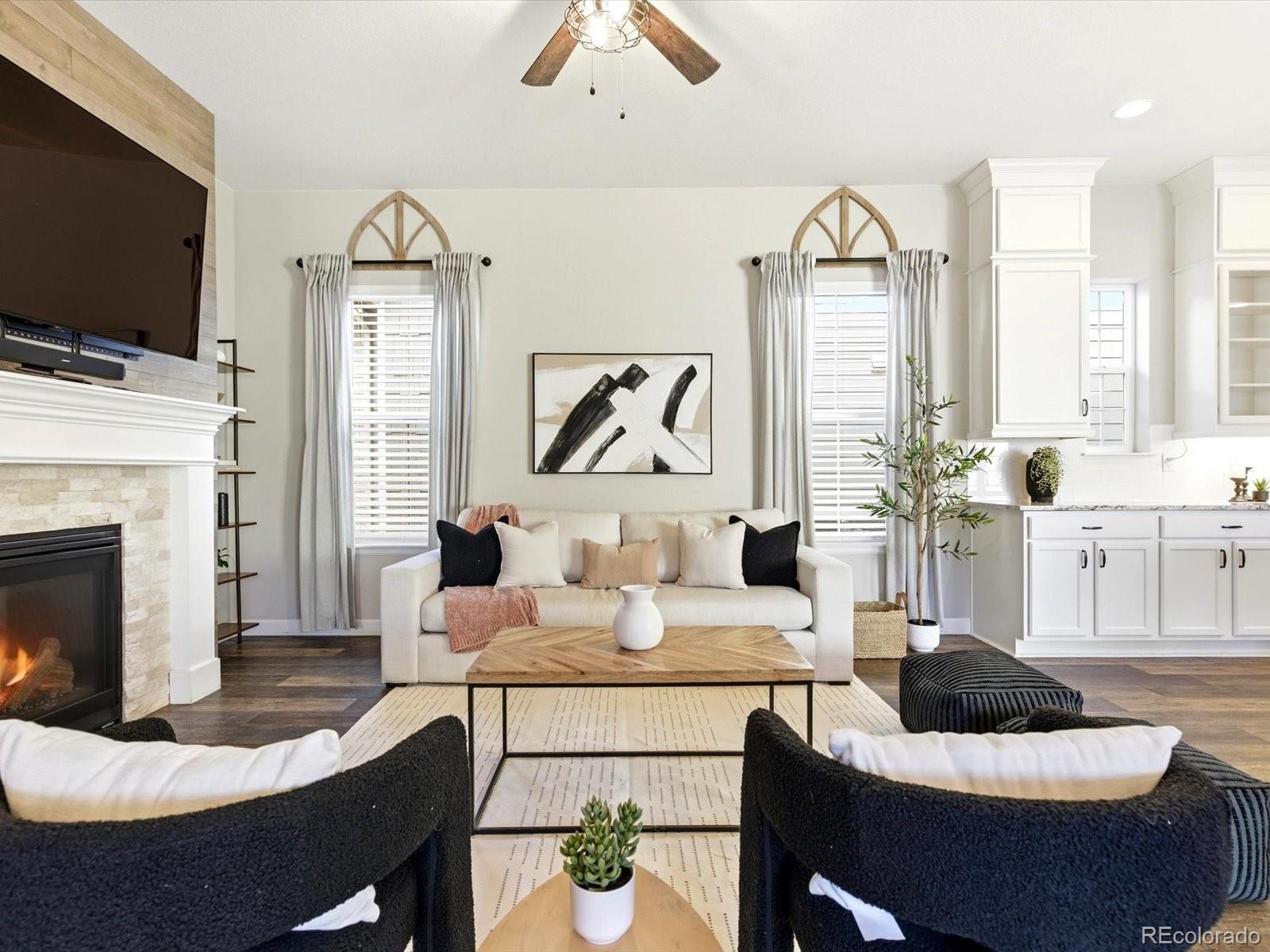 6579 South Vaughn Street Centennial, CO 80111 - Photo 18 of 44 a living room with furniture a fireplace and a flat screen tv