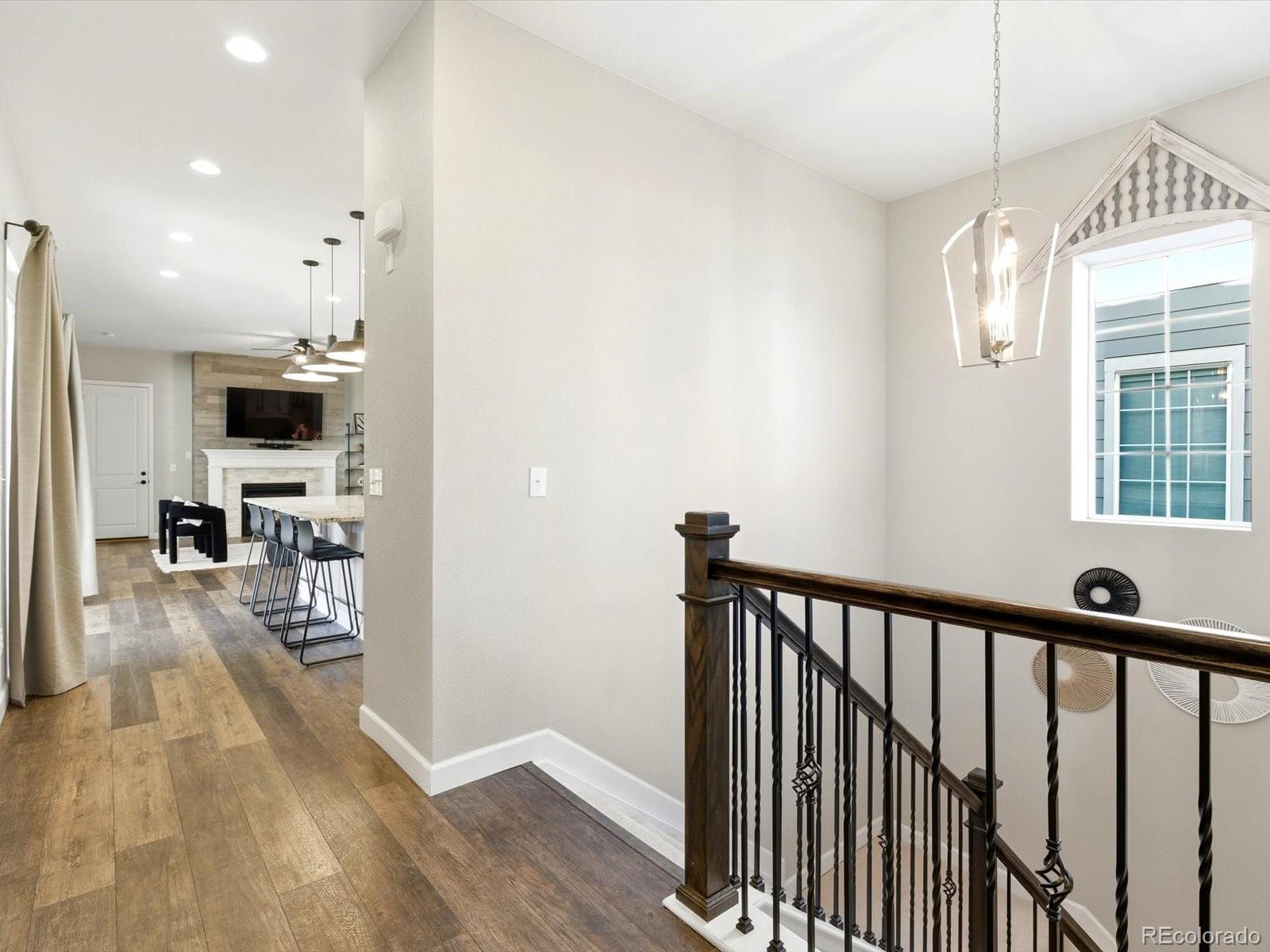 6579 South Vaughn Street Centennial, CO 80111 - Photo 26 of 44 a view of a hallway with wooden floor and a living room