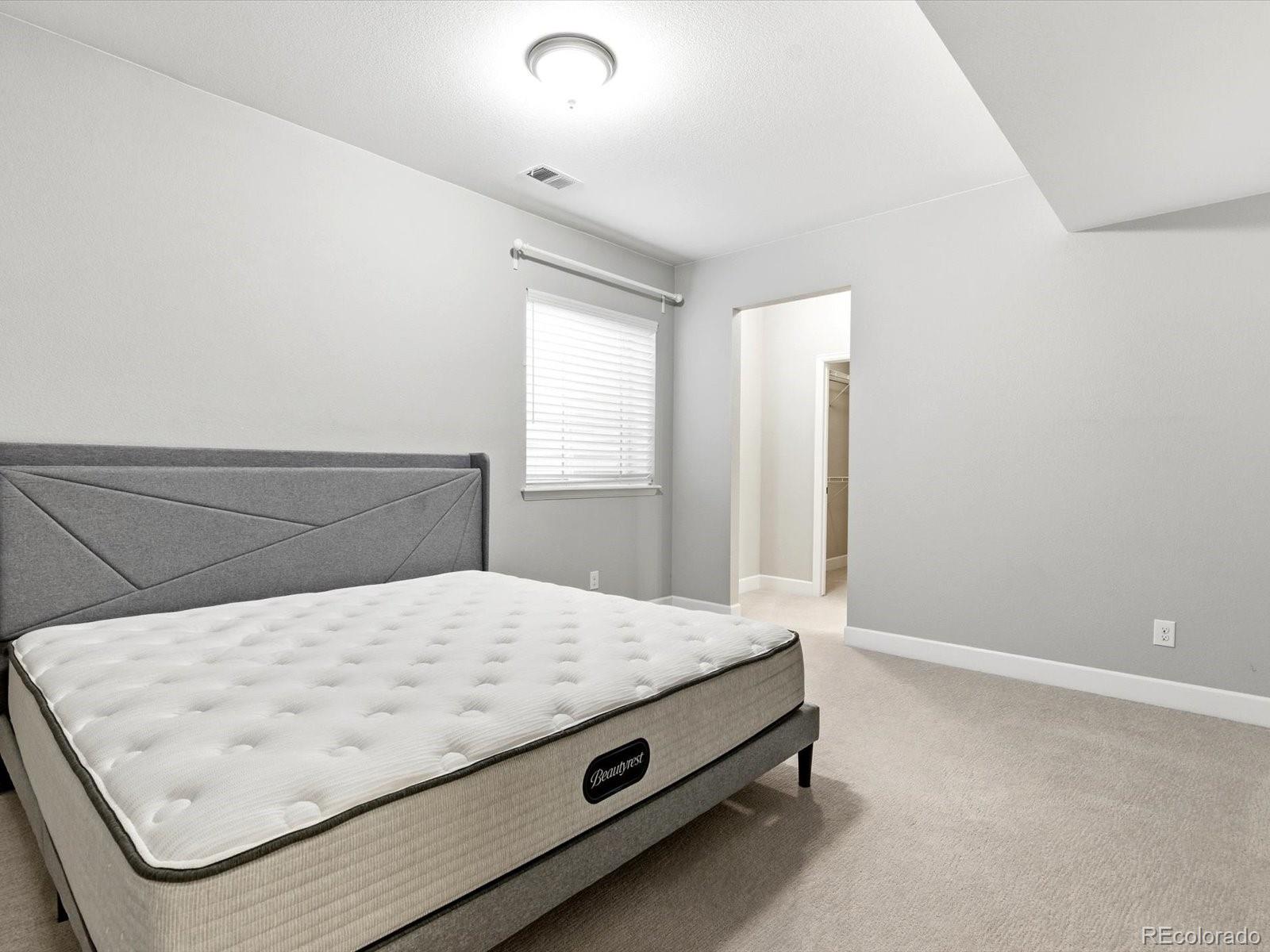6579 South Vaughn Street Centennial, CO 80111 - Photo 39 of 44 a bed sitting in a spacious bedroom next to a window
