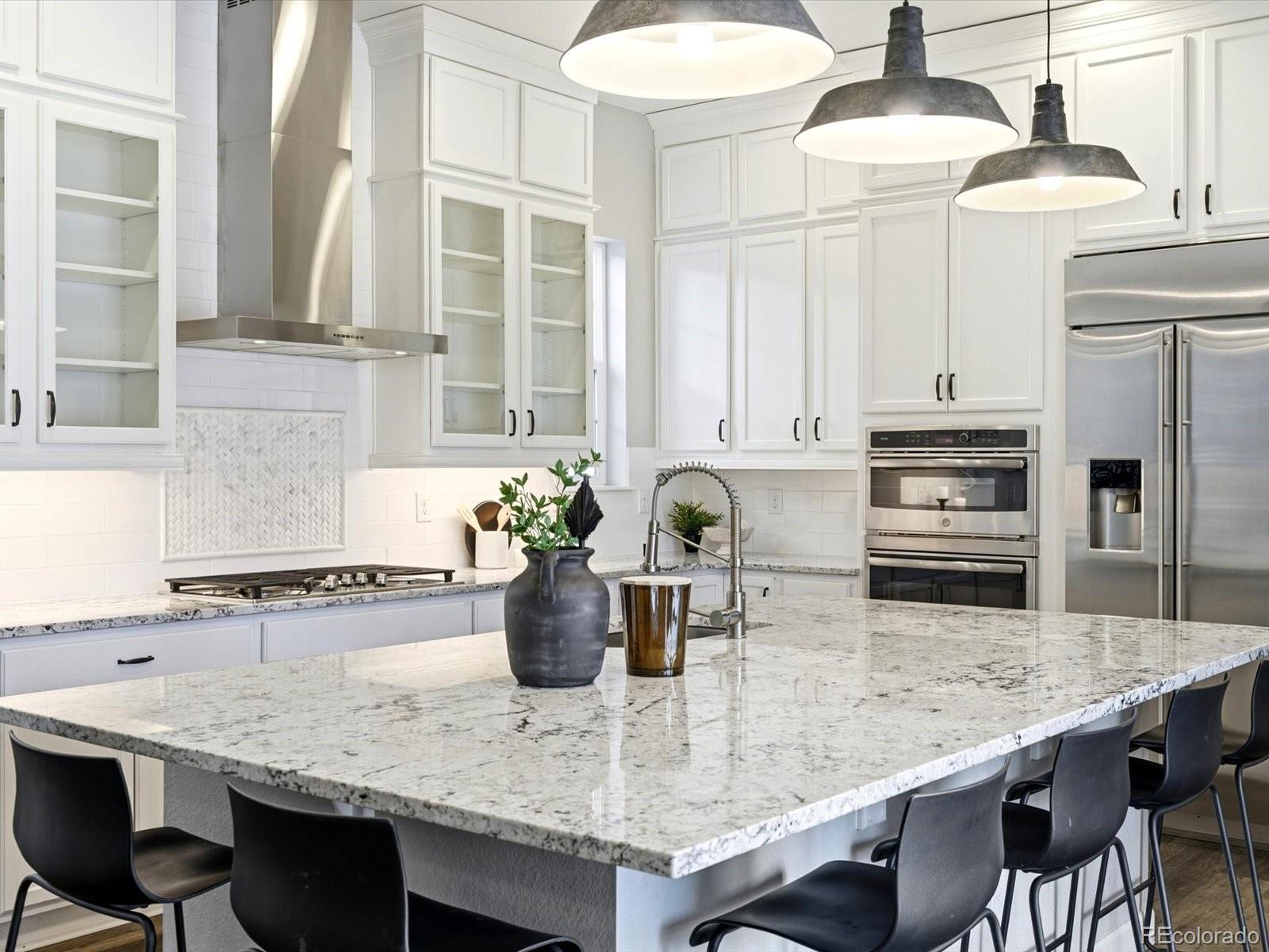 6579 South Vaughn Street Centennial, CO 80111 - Photo 5 of 44 a kitchen with stainless steel appliances granite countertop a stove refrigerator and cabinets