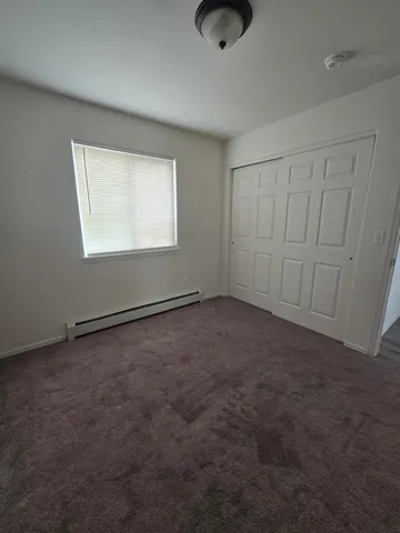 an empty room with a empty space and windows