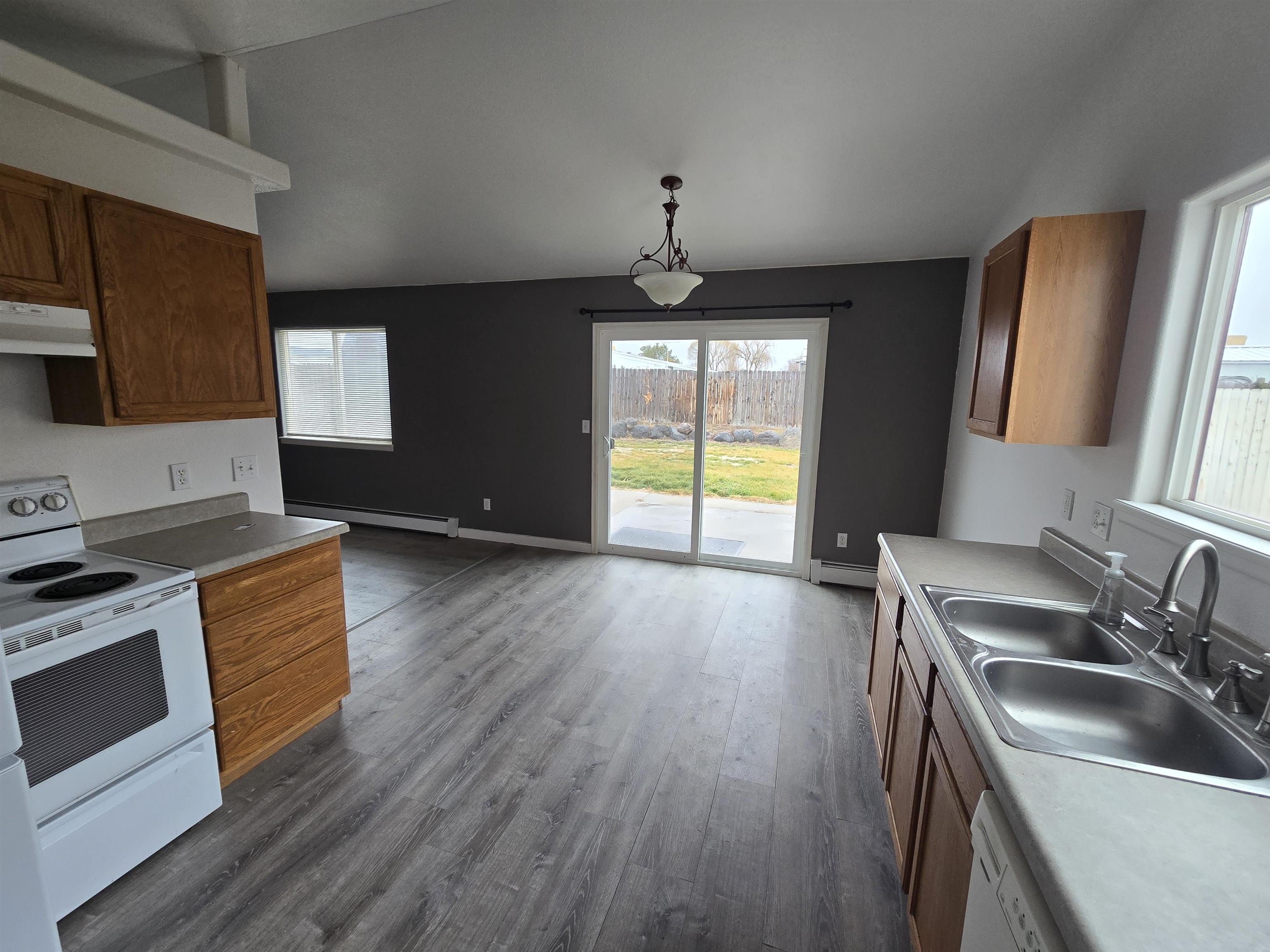 1400 Powell Street Fruita, CO 81521 - Photo 4 of 21 a kitchen with stainless steel appliances granite countertop a sink a stove and a wooden floors