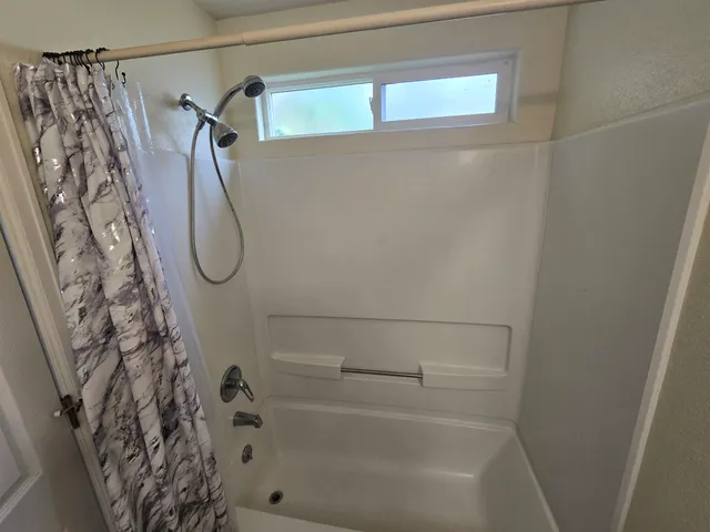 a bathroom with a shower and a bathtub