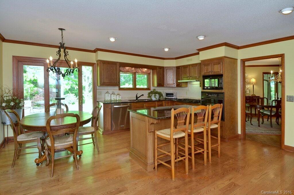 481 Pleasant Hill Road Rutherfordton, NC 28139 - Photo 10 of 15 a kitchen with stainless steel appliances granite countertop table chairs and wooden floor