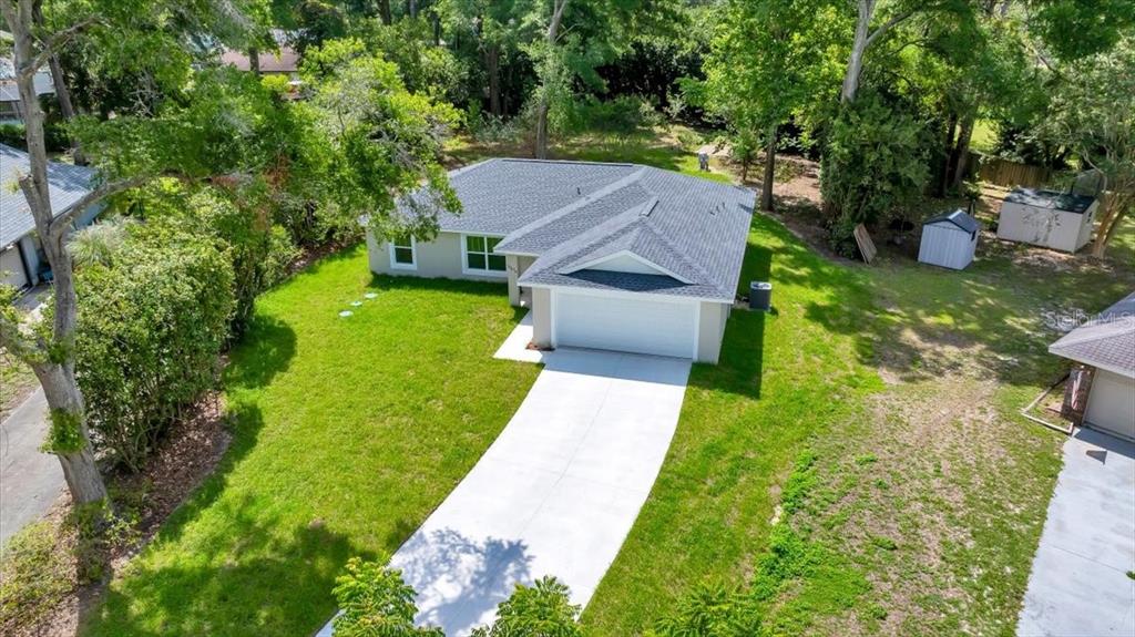 10675 Southwest 69th Terrace Ocala, FL 34476 - Photo 4 of 48 a aerial view of a house with a yard table and chairs