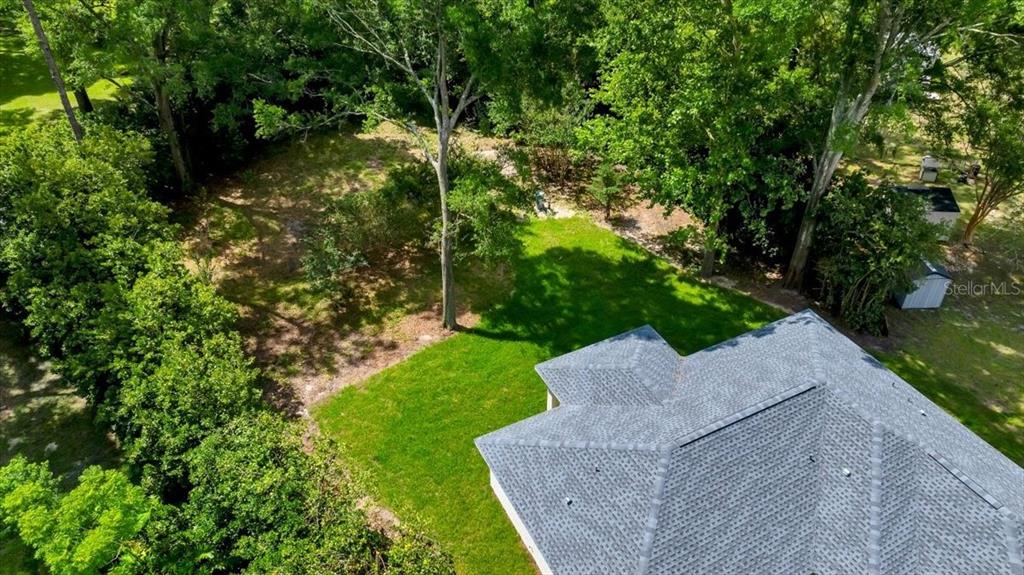 10675 Southwest 69th Terrace Ocala, FL 34476 - Photo 47 of 48 a view of a garden with a tree