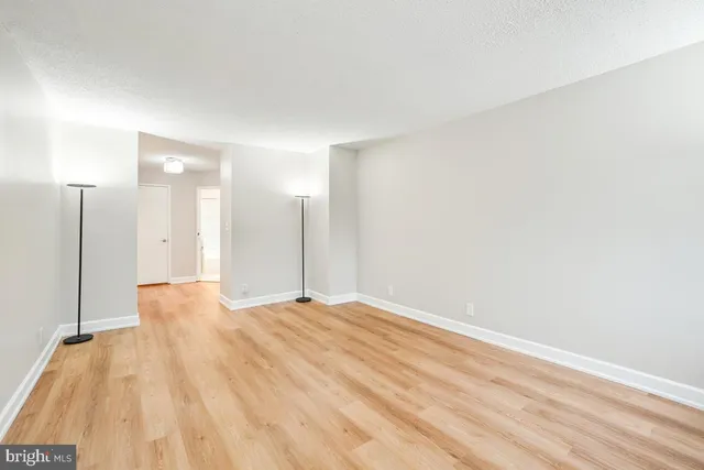 a view of hallway with wooden floor