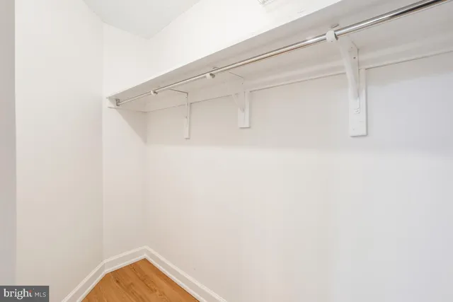 a living room with furniture and a view of kitchen