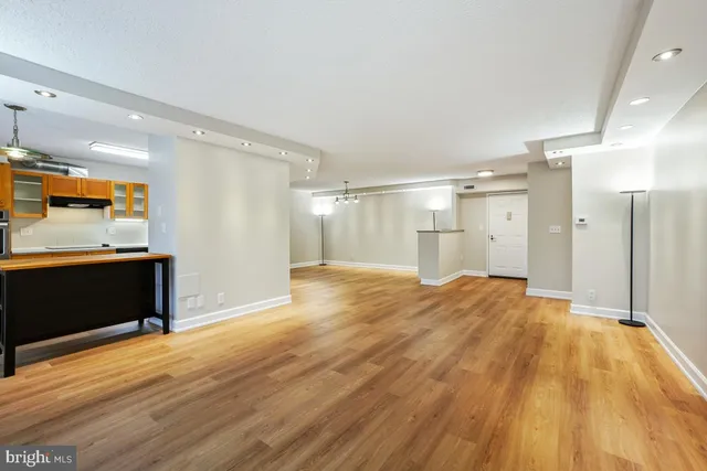 a large kitchen with kitchen island a stove a sink dishwasher and wooden cabinets