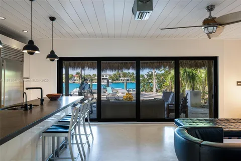 a kitchen with a refrigerator a sink and a stove top oven
