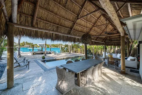 a view of swimming pool with a table and chairs