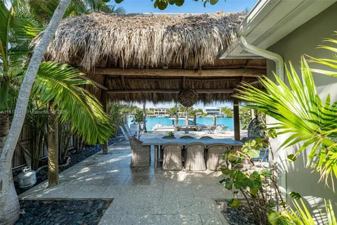 a living room with furniture flat screen tv and a large window