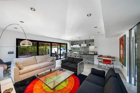 a bedroom with a bed a desk and chair with the potted plants