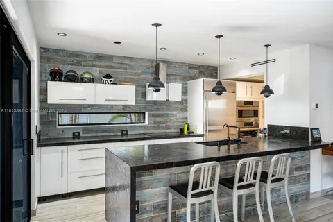 a bathroom with a glass shower door and a glass door shower