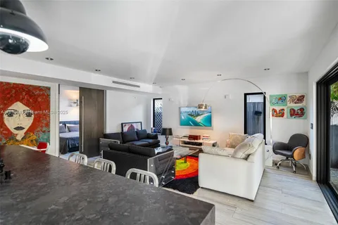 a living room with furniture and a mirror