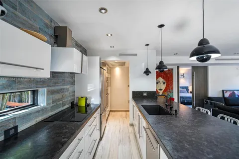 an aerial view of a house with a yard and lake view