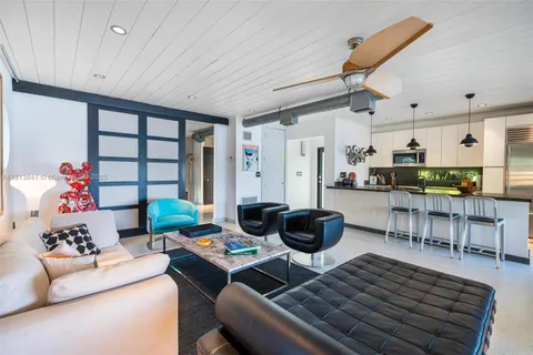 a living room with furniture a window and a chandelier