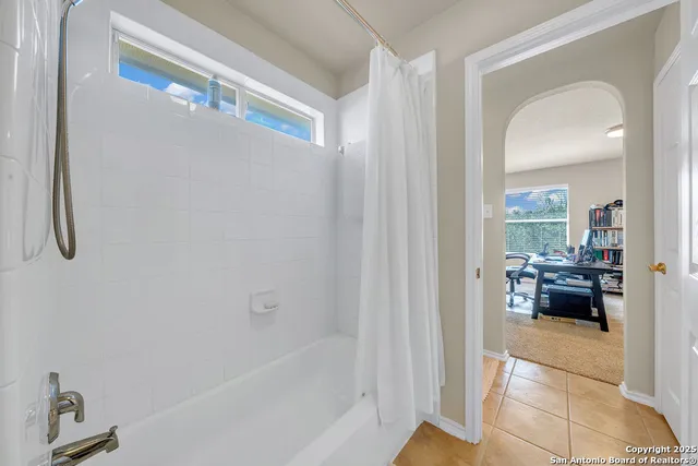 a en suite bathroom with a tub and view of bathroom