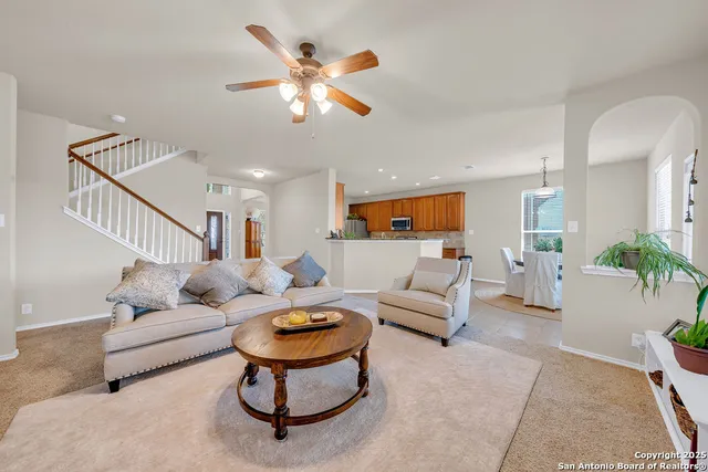a living room with furniture and kitchen view