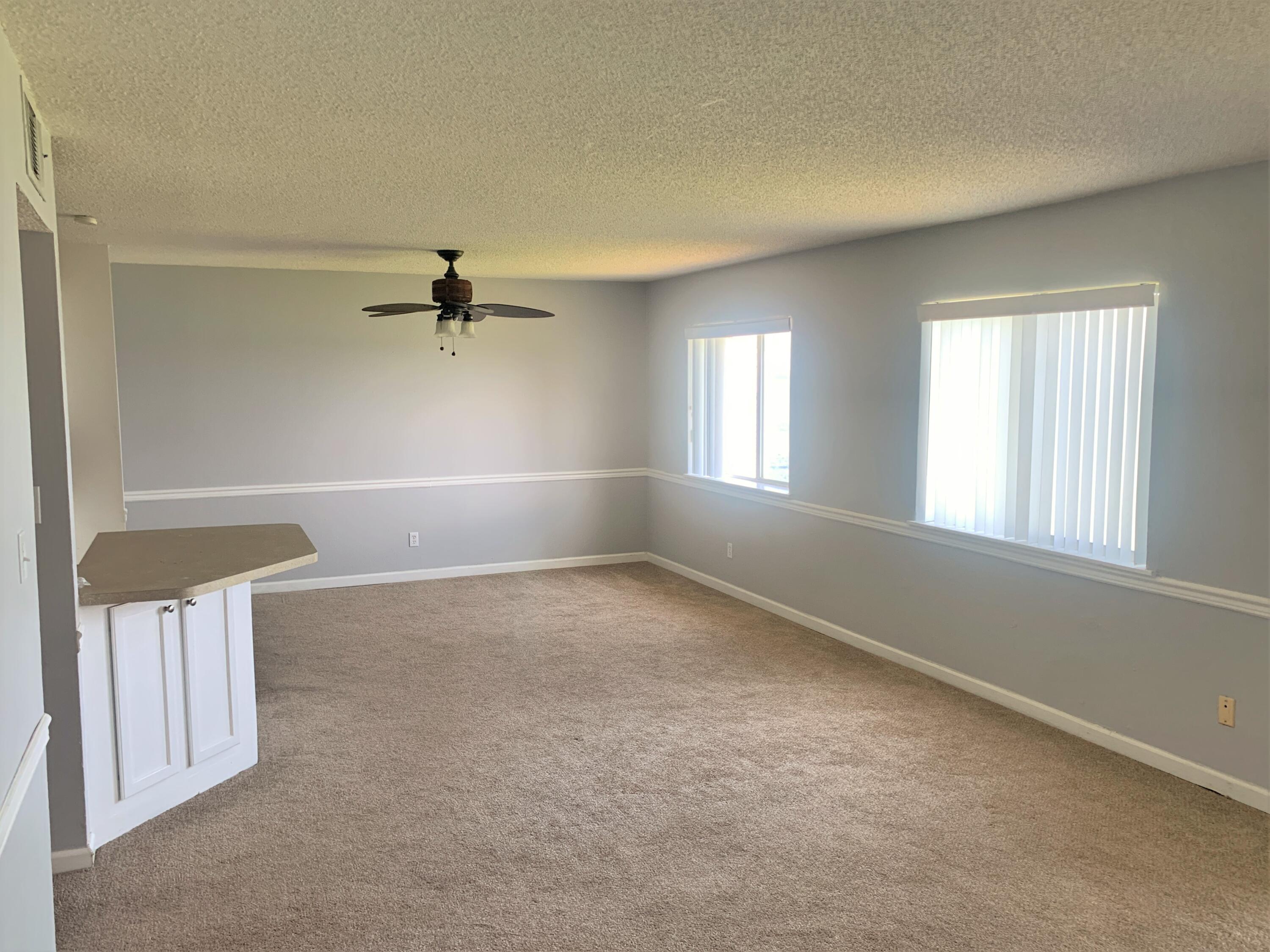 101 Old Ferry Road, Unit 15D Shalimar, FL 32579 - Photo 4 of 11 wooden floor in an empty room with a window