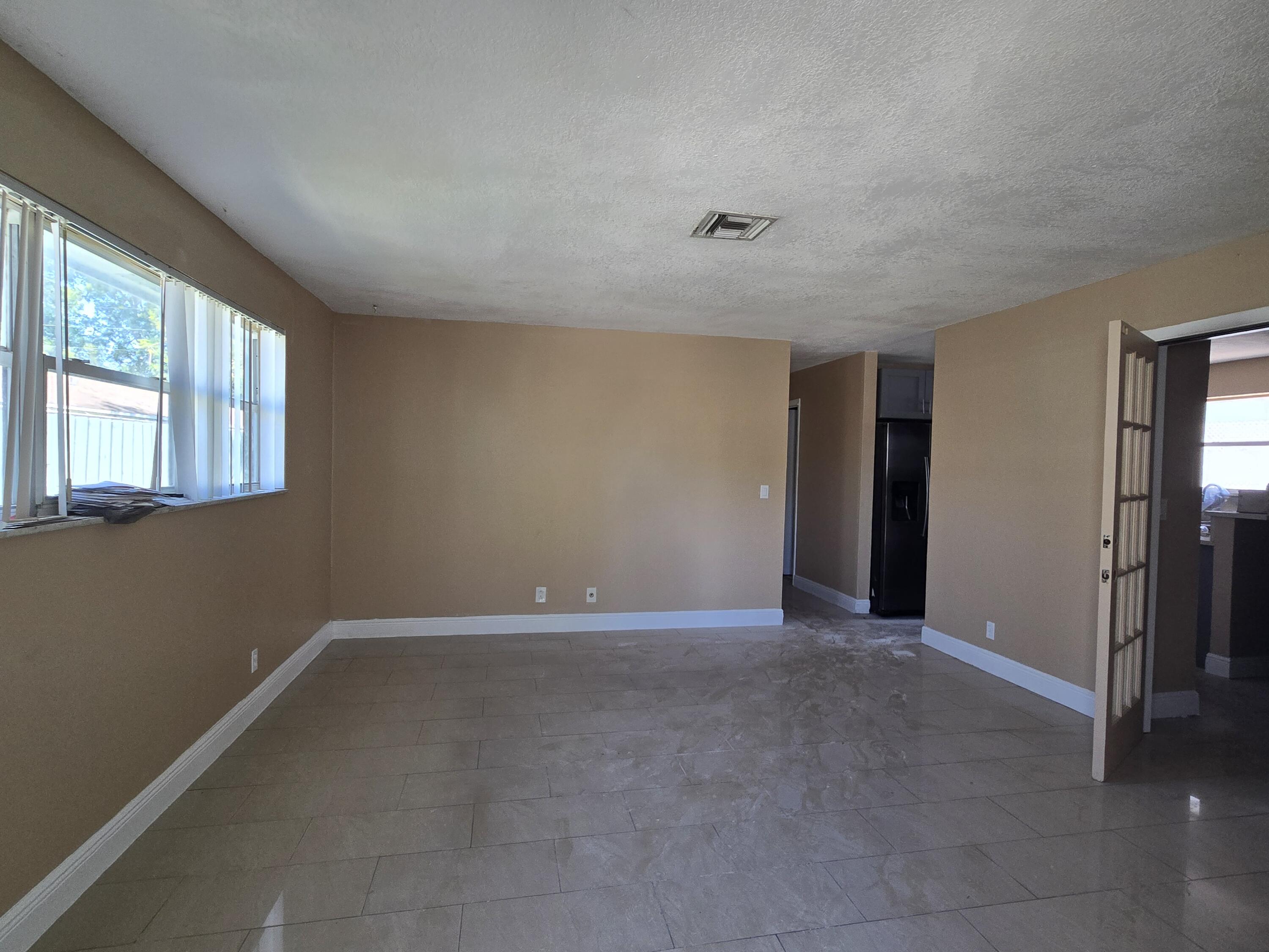 815 Silver Beach Road Lake Park, FL 33403 - Photo 3 of 7 an empty room with windows