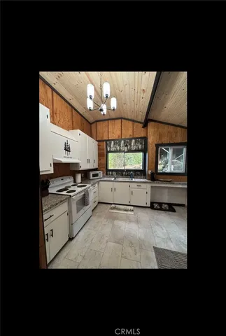 a view of a kitchen with kitchen island and stainless steel appliances