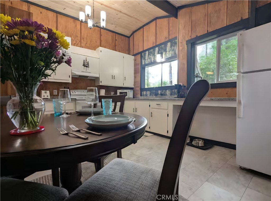 16135 Bottle Rock Road Cobb, CA 95426 - Photo 6 of 19 a kitchen with a table chairs stove and cabinets