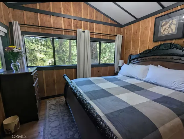 a bedroom with a bed and a large window