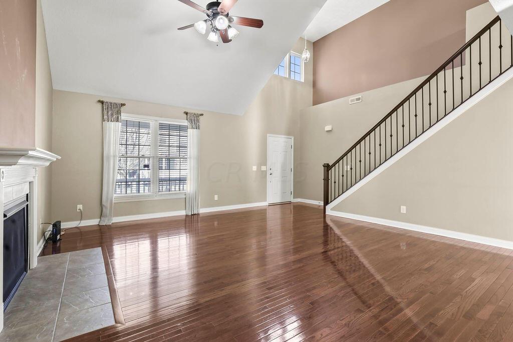 6163 Jennis Road Westerville, OH 43081 - Photo 5 of 44 • Hardwood flooring
• Tan painted walls
• Vaulted ceiling
• Lighted ceiling fan
• Gas log fireplace with
mantle
• Closet under stairs
• 2” blinds
• Drapes remain