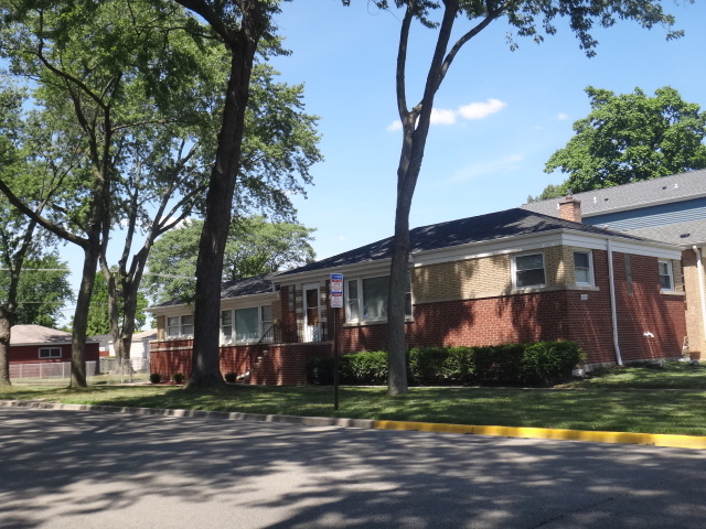 a front view of house with yard and green space