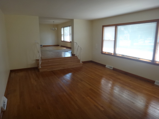 4044 Clinton Avenue Stickney, IL 60402 - Photo 4 of 11 an empty room with wooden floor and windows