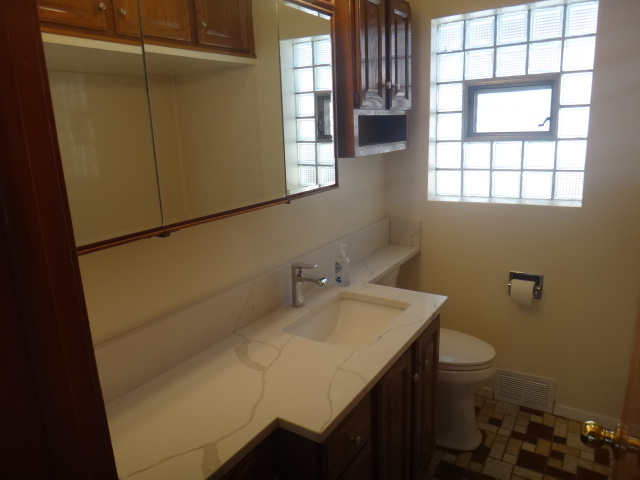 4044 Clinton Avenue Stickney, IL 60402 - Photo 7 of 11 a bathroom with a sink and toilet